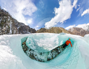 Female inside the crack in the ice glaciers Iceland. Wide-angle panorama