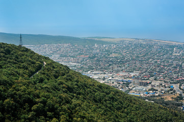 Aerial view of the city at the foot of the green hill. Black Sea, Russia