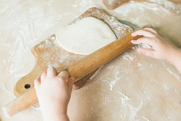 A child rolled raw dough