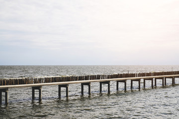 Fototapeta premium long bridge beside water pier