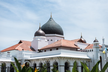 A proud muslim temple against a blue sky in Malaysia