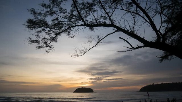 4K Time - lapse Activities on the beach with Silhouette tree and colorful sunset  at sunset time , Phuket Thailand.