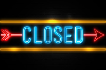 Closed  - fluorescent Neon Sign on brickwall Front view