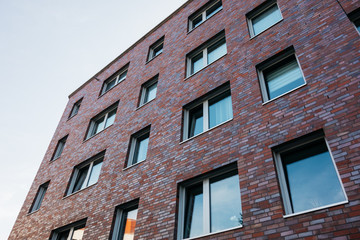 Obraz premium brick facade apartment building in low angle view