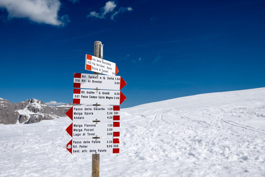 Signpost in snowy Alpine mountains - Madonna di Campiglio ski center in Italy