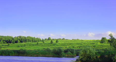 The river, shore and sky in summer day