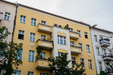 Fototapeta premium old apartment building with yellow facade