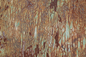 Weathered once painted metal surface with lot of rust