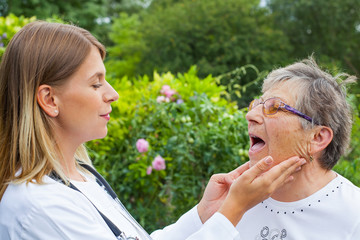 Doctor examining sore throat