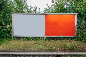 two advertising poster on rails
