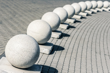 Concrete spheres on a sidewalk