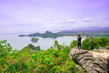 A young traveler girl  on the top of mountain enjoy the beauty of seascape Top View Landscape  beach at Prachuab Khirikhan povince Thailand