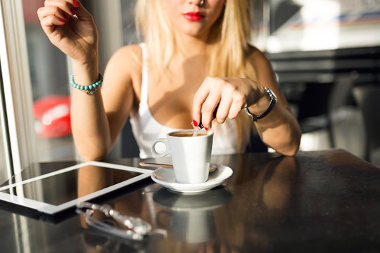 Beautiful young woman drinking coffee at a coffee shop.