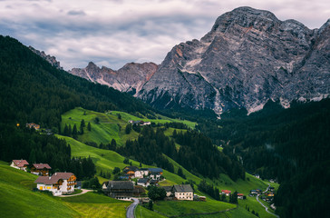 Fototapeta na wymiar Top view of the small alpine village nearby La Valle (La Val) in Dolomites. Trentino Alto Adidge, Italy.