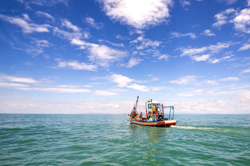 Fishing boat on a sea and deep bluesky background,Thailand
