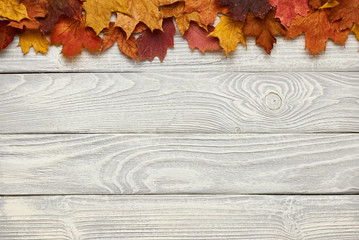 Wooden background with autumn leaves