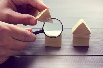 inspection of construction objects/ viewing in a magnifying glass the design of a house layout