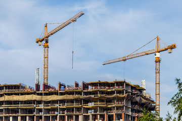 Crains on construction site of building