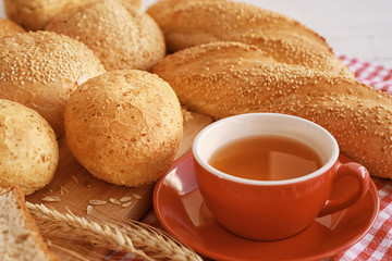 Delicious bread and cup of tea on wooden table