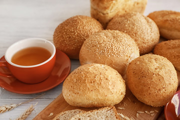 Delicious bread and cup of tea on wooden table