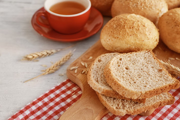 Delicious bread and cup of tea on wooden table