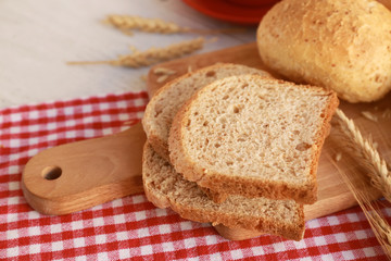 Delicious bread slices on table