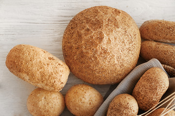 Beautiful composition with delicious bread on wooden table