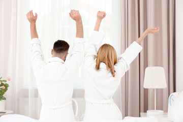 Morning of happy young couple resting in hotel room