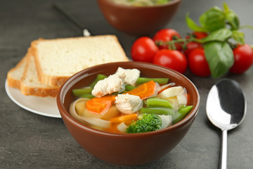 Bowl with delicious turkey soup on table