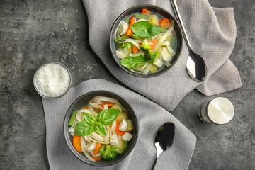 Two bowls with delicious turkey soup on table