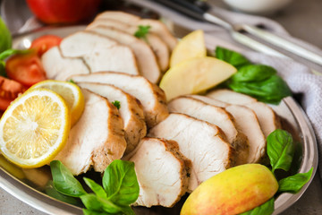Plate with delicious sliced turkey fillet, closeup