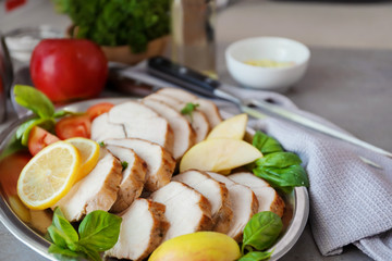 Plate with delicious sliced turkey fillet on table