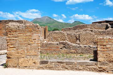 POMPEII, ITALY, JULY 2, 2017: Ancient eruption ruins in the city of Pompeii with the volcano...
