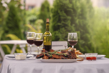 Delicious ribs served for dinner on table