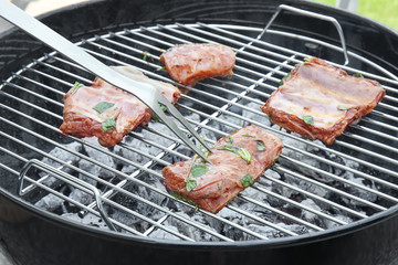 Cooking of appetizing juicy spare ribs outdoors