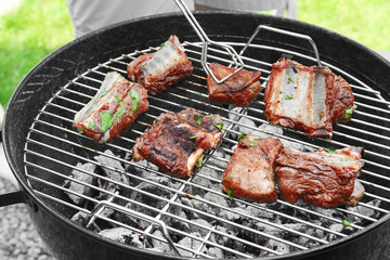 Cooking of appetizing juicy spare ribs outdoors