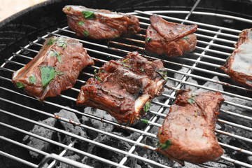 Cooking of appetizing juicy spare ribs outdoors