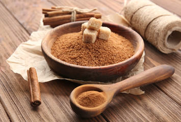Composition with cinnamon sugar and powder on wooden background