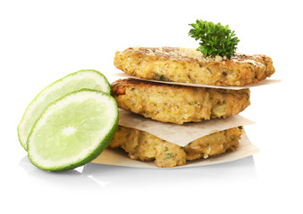 Broccoli pancakes served with lime slices and grated cheese on white background