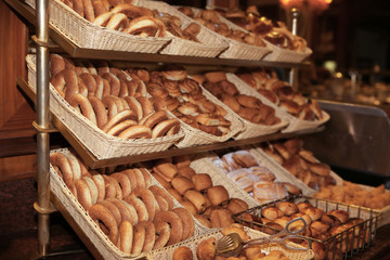 Different kinds of bakery products in baskets at buffet