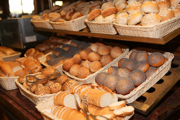 Different kinds of bakery products in baskets at buffet
