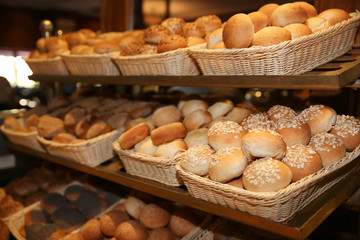 Different kinds of bakery products in baskets at buffet