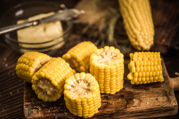 Cooked and salted corn on cob with butter