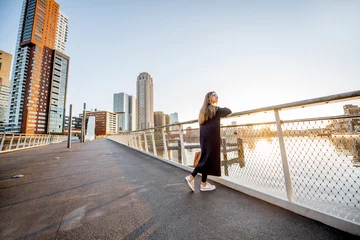 Photo sur Plexiglas Rotterdam Woman enjoying modern cityscape view standing on the bridge during the morning in Roterdam city