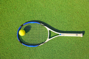 Tennis ball and racket on court