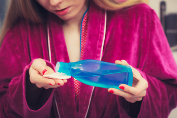 Woman applying tonic on cotton pad