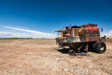 Fototapeta premium Accidental and burned tractor for grain processing