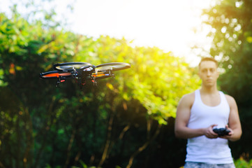 Naklejka na ściany i meble Remote controle of drone. Drone flying outdoor