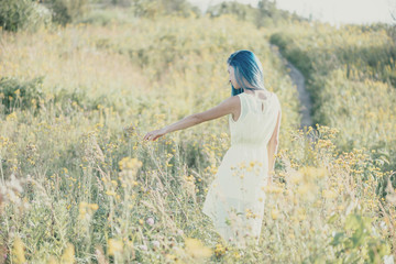 Woman walking on wildflower meadow.