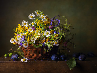 Still life with wild flowers in a basket